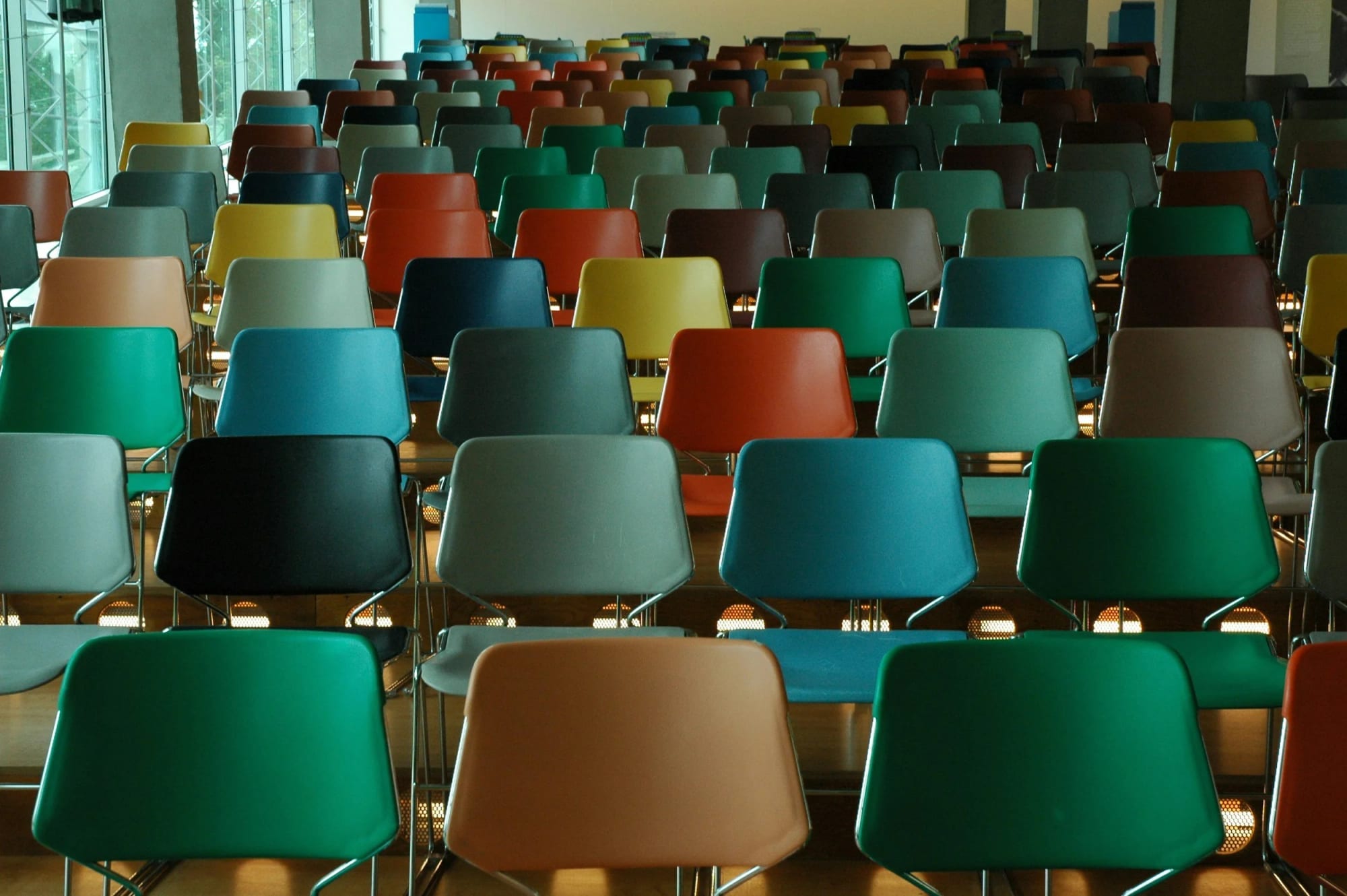 Rows of empty, colorful chairs in an auditorium