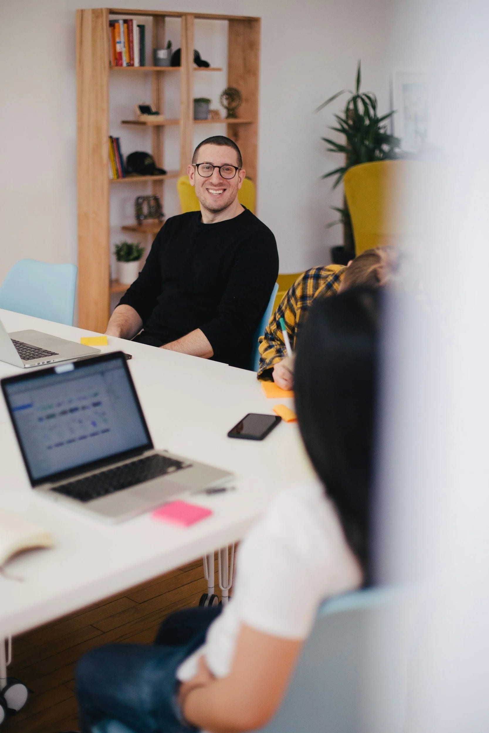 Colleagues talking around a table in a bright, modern office
